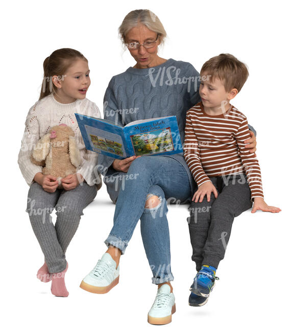 grandmother sitting and reading a book to her grandchildren