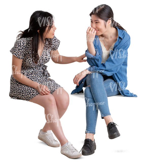 two young asian women sitting and talking
