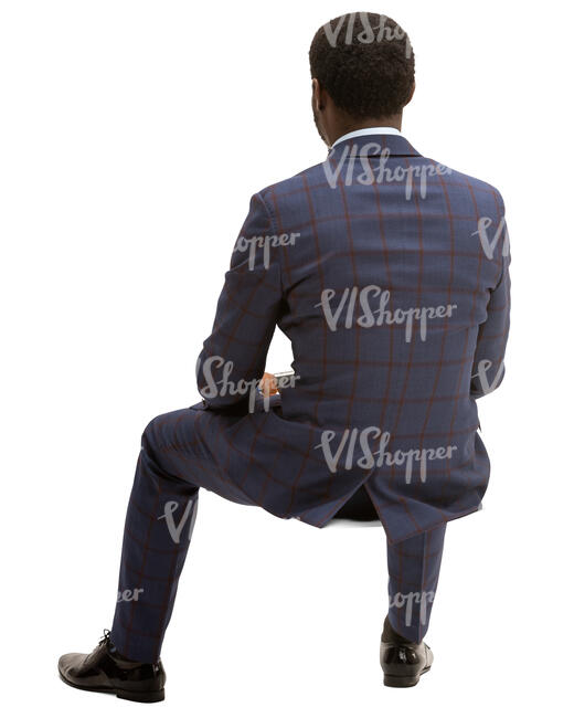 black man in checkerd suit sitting