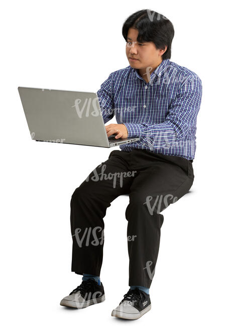 asian man sittinf behind a desk with laptop