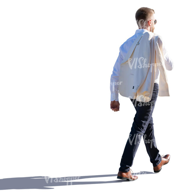 backlit man walking with a jacket over his shoulder
