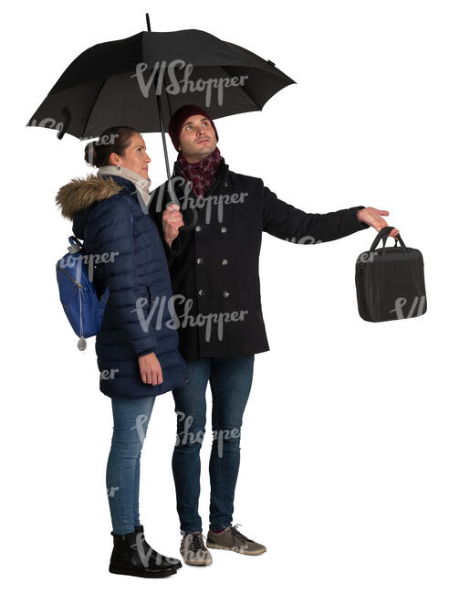 man and woman standing under the umbrella