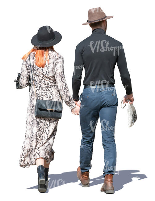 couple with hats walking hand in hand