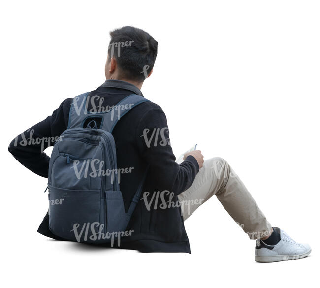 asian man sitting on a sidewalk