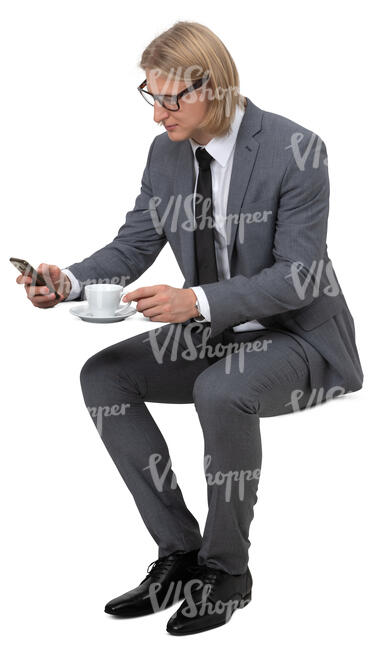 man in a suit drinking coffee in a cafe
