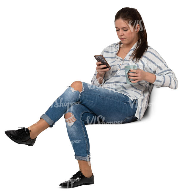 woman with a coffee mug sitting and texting