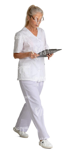 older nurse with some papers walking