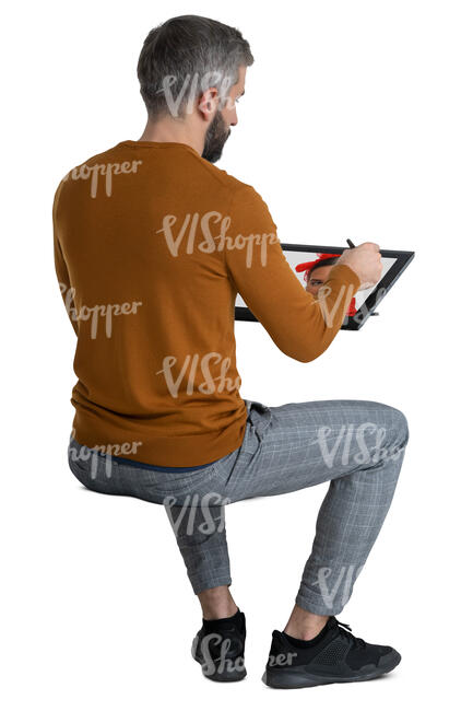 man sitting and drawing on computer
