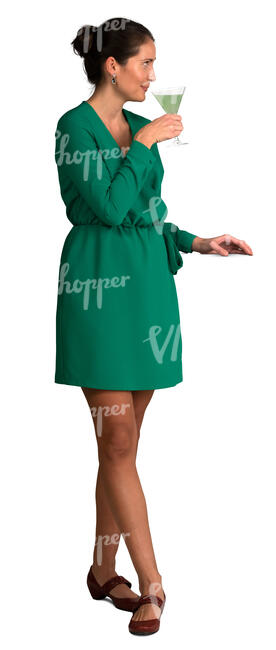 woman in a green dress drinking cocktail