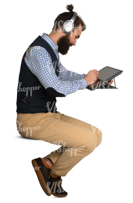 man sittin at a desk and drawing on a graphic tablet