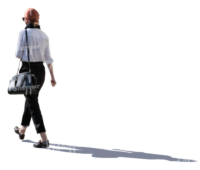 backlit woman walking on a street