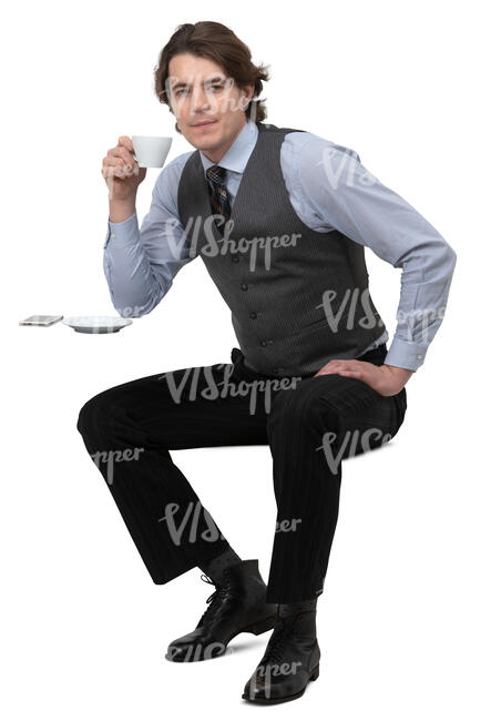 man in a tie and vest sitting in a cafe