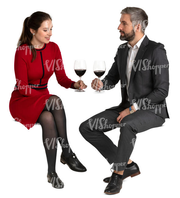 man and woman sitting in a restaurant and drinking wine