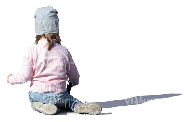 little girl sitting on the ground