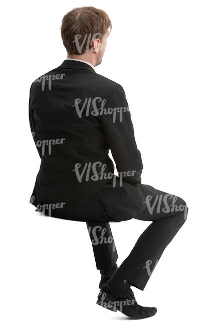 man in a black suit sitting