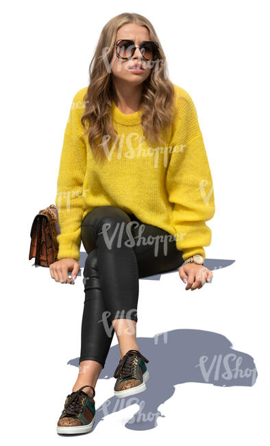 woman in a yellow knit sweater sitting
