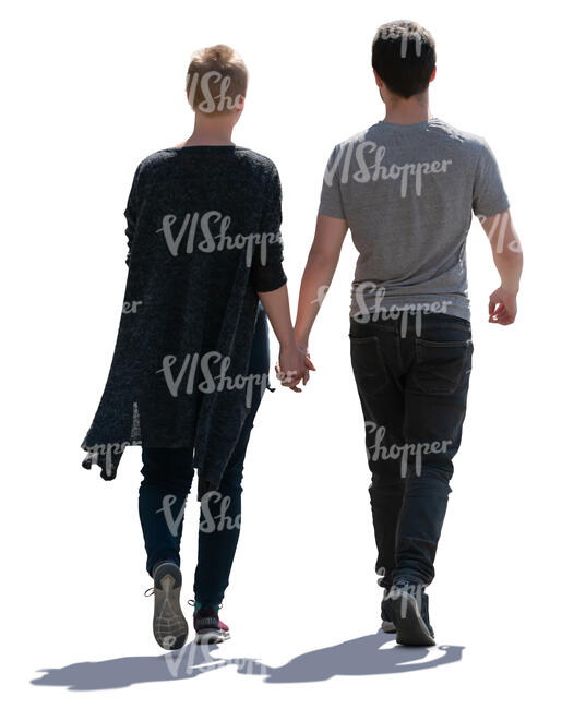 backlit couple walking hand in hand