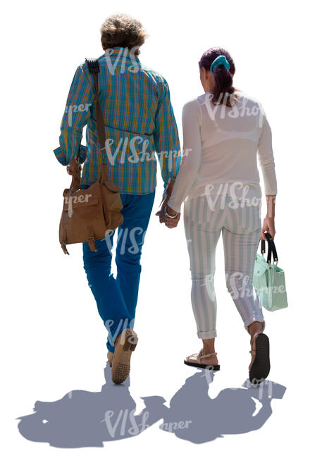 elderly backlit couple walking hand in hand