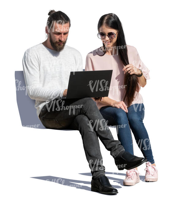 man and woman sitting and looking at a laptop