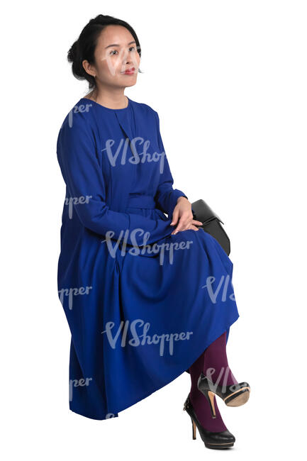 asian woman in a blue dress sitting