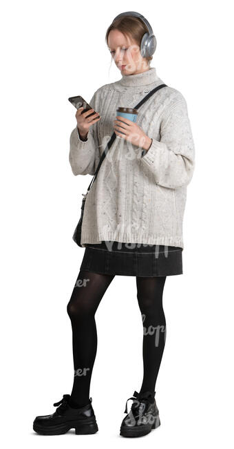 woman with headphones standing and drinking coffee