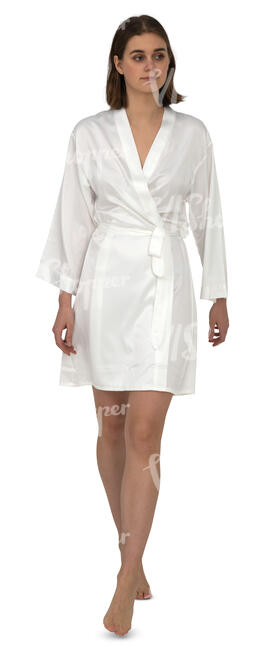 woman in a white silk bathrobe walking