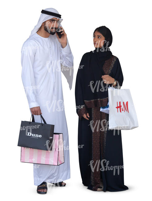 arab man and woman with shopping bags standing