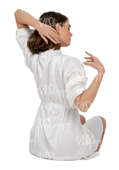 woman in a white bathrobe sitting