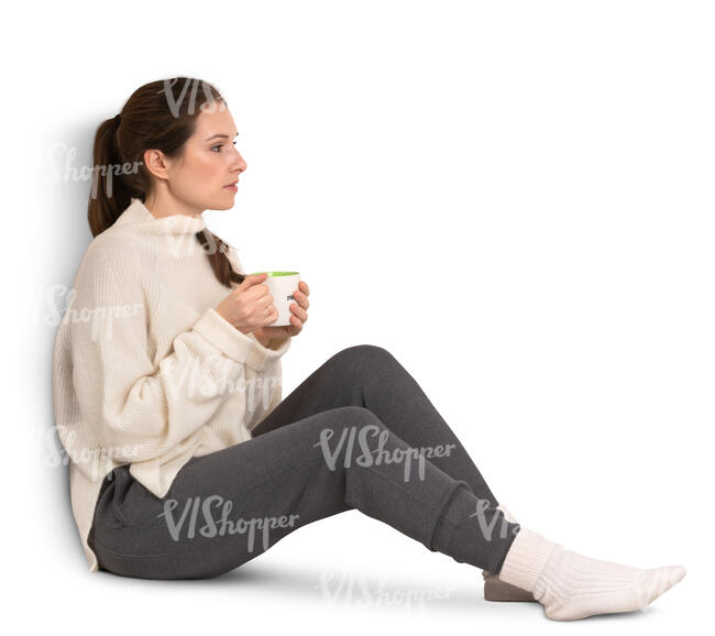 woman with a coffee mug sitting by the window