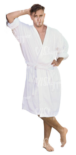 man in a white bathrobe leaning against the wall