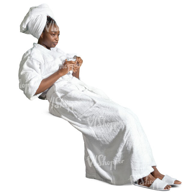 woman in a spa bathrobe drinking water