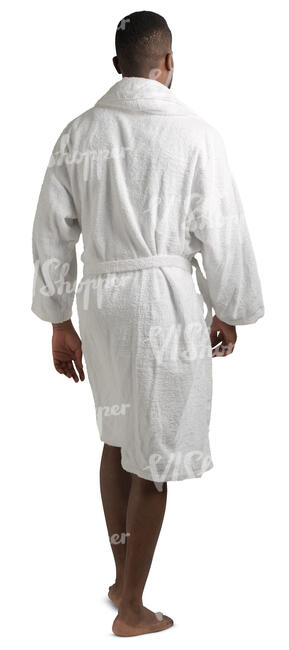 african man in a white bathrobe walking