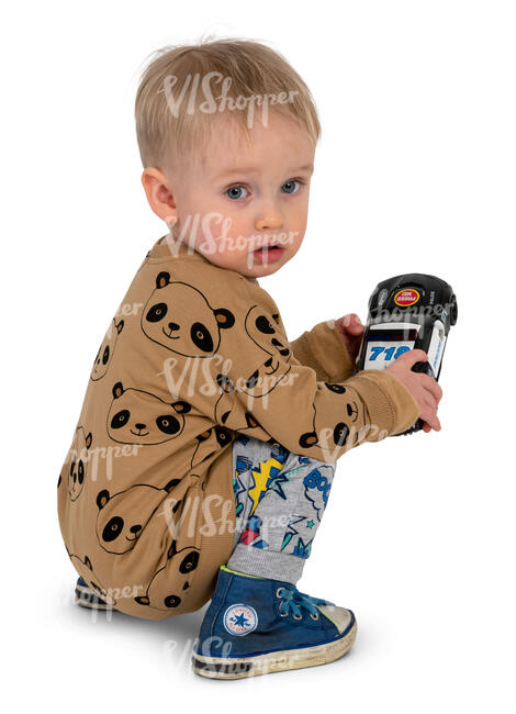 little boy playing with his toy car