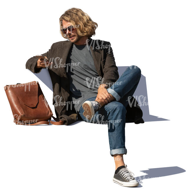 man sitting on a bench and checking his phone