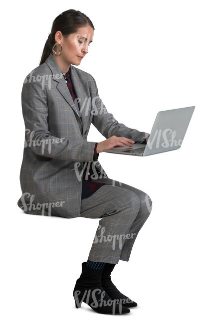 woman in a grey costume sitting and working with laptop