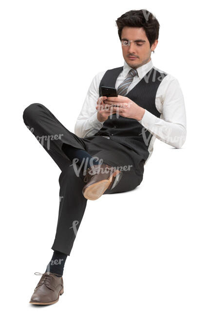 man in a formal suit vest sitting and texting