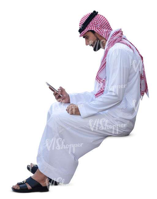 arab man in traditional clothing sitting and texting