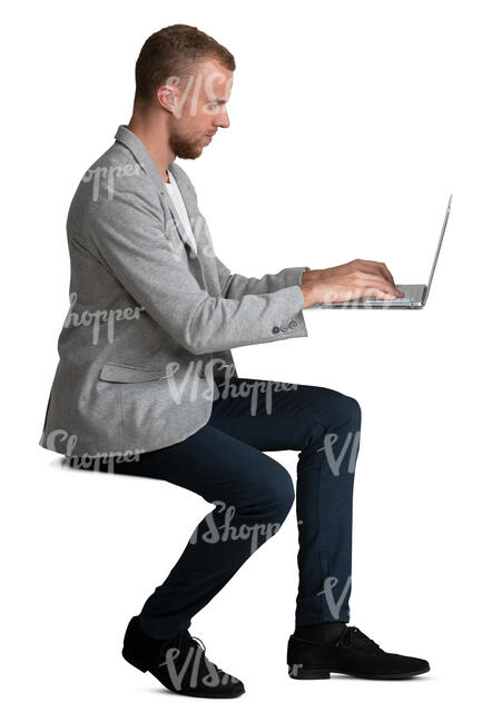 man sitting and working with laptop at the desk