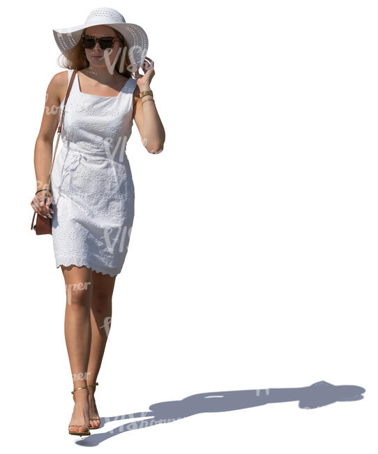 woman in a white summer dress and hat walking
