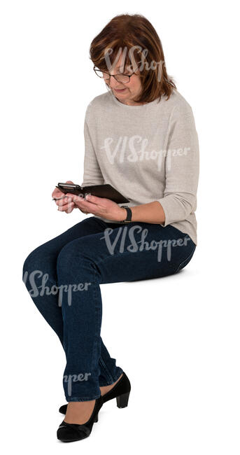 senior woman sitting and looking at her phone