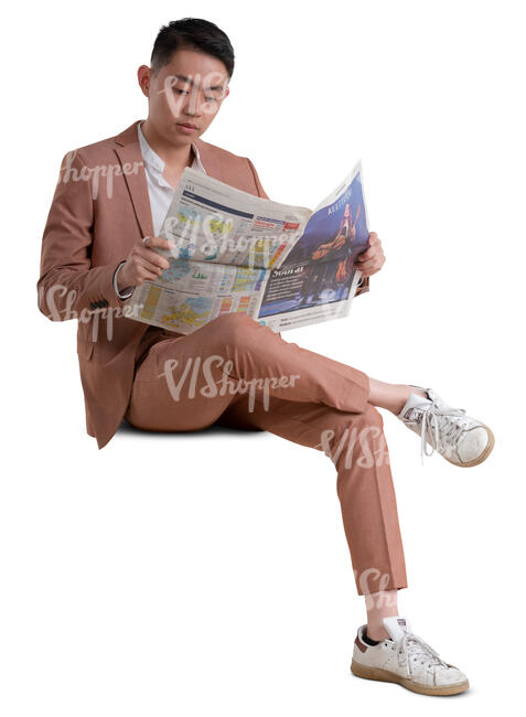 asian man in a pink suit sitting and reading a newspaper