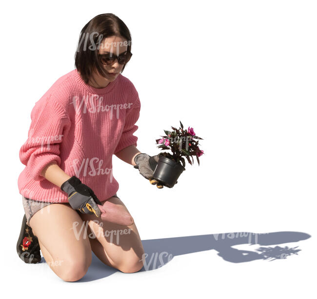 woman planting a flower in the garden