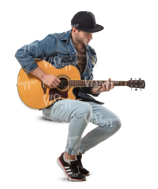 man sitting and playing a guitar