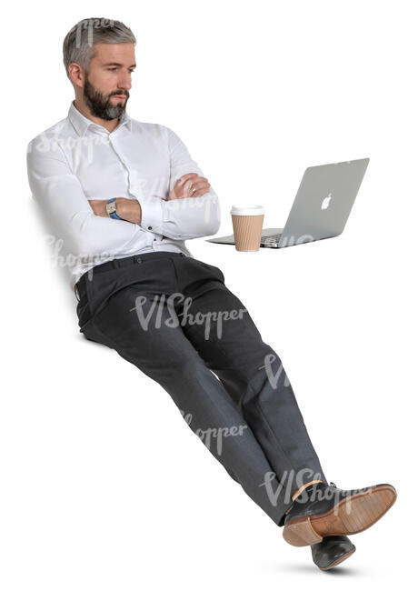 businessman sitting at a desk and drinking coffee