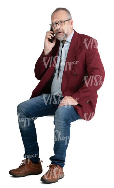 old man sitting and talking on a phone