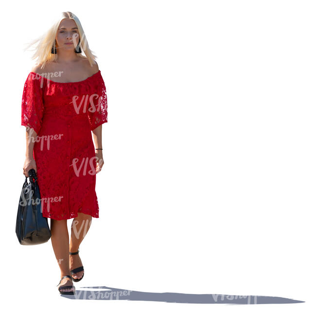 backlit woman in a red dress walking
