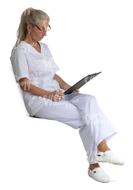 female nurse sitting and reading some papers