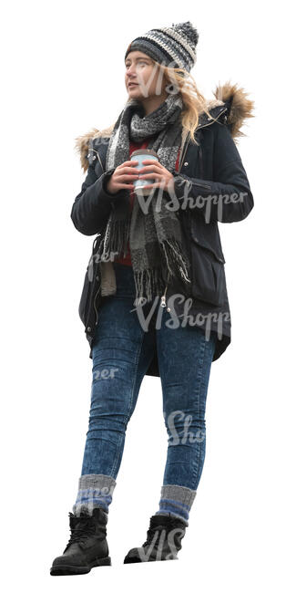 woman in a winter coat standing on a balcony and drinking coffee