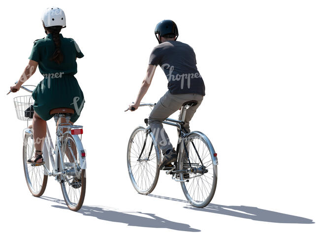 backlit man and woman cycling side by side