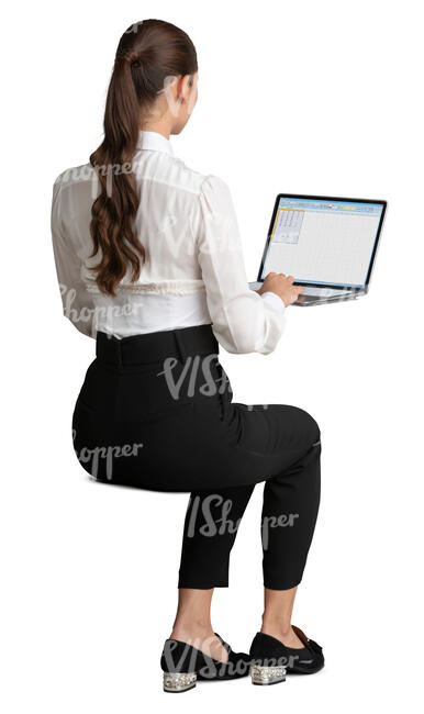 young woman sitting at an office table and working